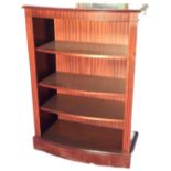 A bowfronted mahogany bookcase cabinet with moulded top above adjustable shelves framed by fluted