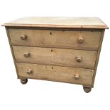 A small Victorian pine chest of three long knobbed drawers, raised on bun feet. (35.5in x 19in x