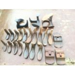 Seventeen cast iron cobblers shoes of miscellaneous graduated sizes with three shaped stands; and