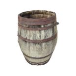A large bulbous oak barrel, the staves bound by eight riveted metal strap bands. (37in)