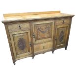 A late Victorian carved oak sideboard, the rectangular moulded top with upstand, above drawers and