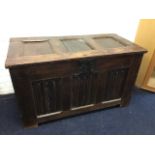 An eighteenth century oak coffer with three panels to hinged lid, having lined interior and original