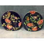 A pair of Maling rack plates decorated with roses on goodes blue spatter ground - one with