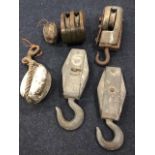 Four shaped hardwood tackle blocks with pulley wheels; and two metal examples. (6)