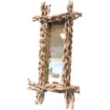 A contemporary rectangular mirror, the white painted frame entwined with naturalistic twigs. (47.