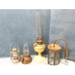 A hexagonal brass hall lantern with bevelled glass panes; a painted brass Aladdin oil lamp with