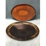 An oval mahogany drinks tray with chequered banding to gallery, mounted with brass scrolled handles,