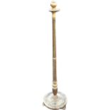 A gilded standard lamp, the fluted tapering column above circular saucer shaped base with beaded