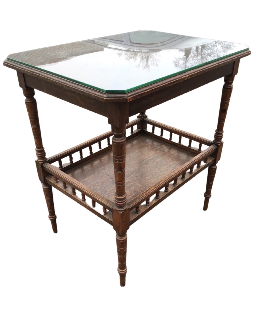A late Victorian oak centre table, the canted moulded top with plate glass on ring-turned legs