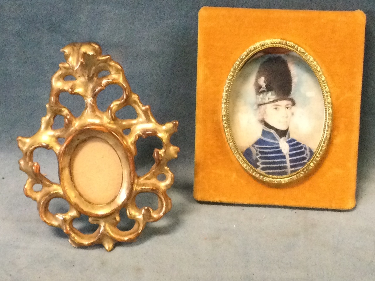 An eighteenth century oval miniature of a soldier in uniform, the panel signed in pencil to verso RH