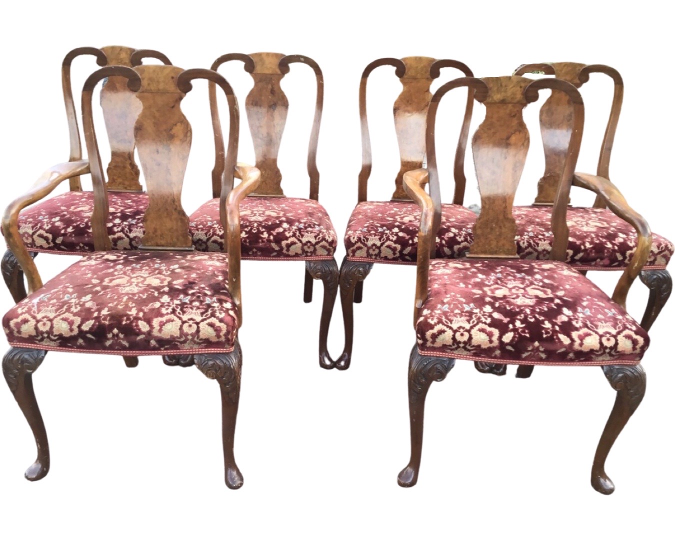 A set of six Queen Anne style walnut dining chairs with vase shaped splats above brocade upholstered