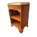 A yew side cabinet with scalloped gallery to ribbed top above an ebony strung drawer, having open