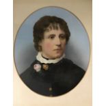 A late Victorian oval overpainted bust portrait of a lady with flowers to her ruff lace collar,