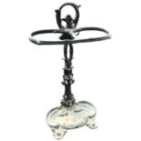 A cast iron stickstand with entwined rail on pierced naturalistic column, above a leaf cast scrolled