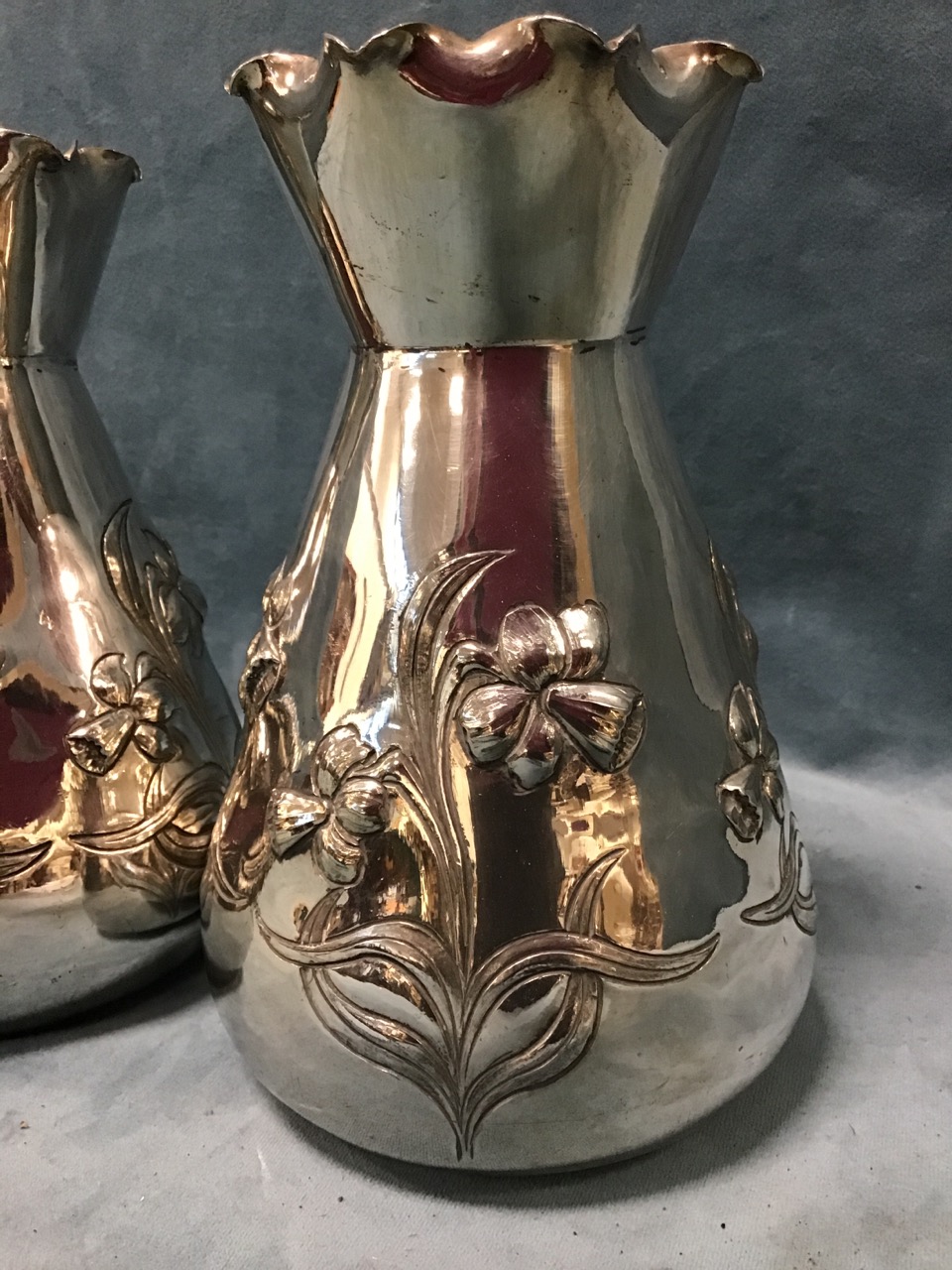 A pair of art nouveau silver plated vases embossed with daffodils to tapering bodies beneath waved - Bild 2 aus 3