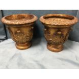 A pair of gilt urns moulded with acanthus leaves to pots having leaf decorated rims, raised on