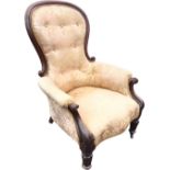 A Victorian mahogany spoonback armchair with spade shaped button upholstered back in cushion moulded