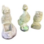 A composition stone garden gnome with barrow; a part-painted moulded stone duck; and a composition
