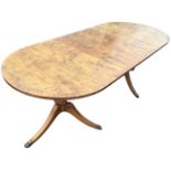 A Georgian style yew dining table, the crossbanded top with rounded ends supported on tapering