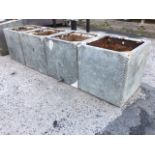 A set of four square riveted galvanised tanks, the flat rims with corner braces - plumbers