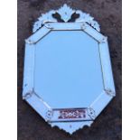 A Venetian mirror with bevelled octagonal plate framed by acid etched and facet cut rectangular