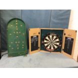 A modern cased Unicorn dartboard, the hinged doors with blackboard scoring panels; and an old Chad
