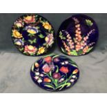 Three Maling rack plates decorated with cobalt blue grounds - azaleas & butterflies, tulips &