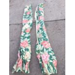 A pair of lined glazed cotton floral chintz curtains printed with pink flowers on green ground