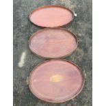 Three oval country house mahogany trays - scalloped gallery, shell paterae inlaid, and chequered