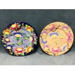 A pair of Maling rack plates decorated with peony flowers and butterflies, one on sponged blue