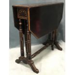 A late Victorian ebonised sutherland type table decorated with gilding to mouldings and carvings,