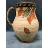 A Charlotte Rhead pitcher by Crown Ducal, the ribbed jug with tube lined autumn leaf decoration
