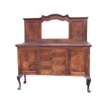 A late Victorian mahogany sideboard, the back with moulded cornice above a shaped bevelled mirror