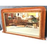 A small rectangular Victorian walnut overmantle mirror, the cushion moulded rounded frame bordered
