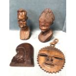 Two African hardwood busts carved out of the solid; a carved rosewood female head plaque; and a