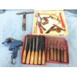 Miscellaneous tools including sets of wood carving chisels, a bench vice, miniature brass planes,