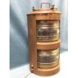 A Bakboord copper cased ships lamp with twin magnifying lenses - each with shaped red internal
