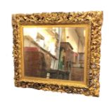 A nineteenth century carved giltwood mirror with wide pierced acanthus scrolled burnished gilt