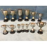 Five 1930s posing cups - best developed man, best physique, etc, on ebonised plinths; and eight