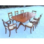 A regency style mahogany dining table, the crossbanded top with rounded ends and ribbed edge with