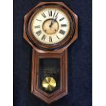A Victorian drop-dial wallclock by The Ansonia Clock Company, the circular dial with roman