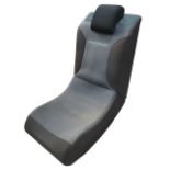 A folding portable Pyramat gaming chair, the shaped upholstered rocking seat with loose headrest.