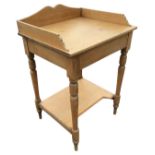 A Victorian pine washstand with shaped gallery to rectangular top, raised on turned tapering legs