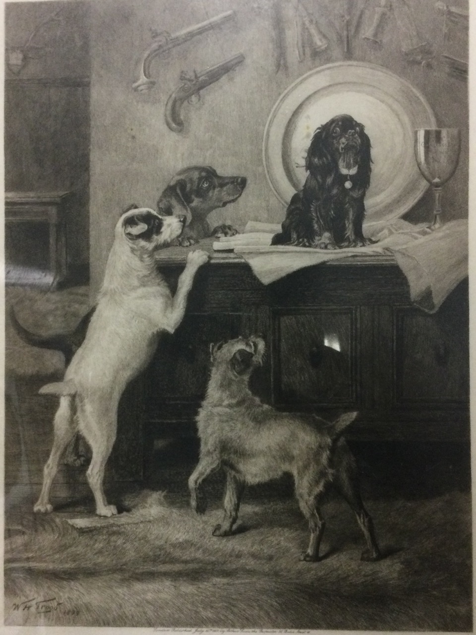 WH Trood, etching, interior scene with four dogs around mule chest, signed in print and dated