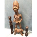 An antique carved African tribal figure of a female holding her child, standing on a dog - 21.