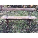 A 5ft Victorian pine bench with shaped back rail on iron mounts above a plank seat, raised on