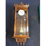 A large Vienna wallclock with seven turned finials to cornice above dentil mouldings, the