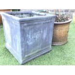 A square faux-lead garden planter with moulded rim and panelled sides cast with tree motifs; and a