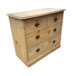 A Victorian pine chest of drawers with two short and two long drawers mounted with brass handles,