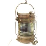 A copper cased ships lantern with brass mounts, the tubular case having gimbal mounts and ribbed